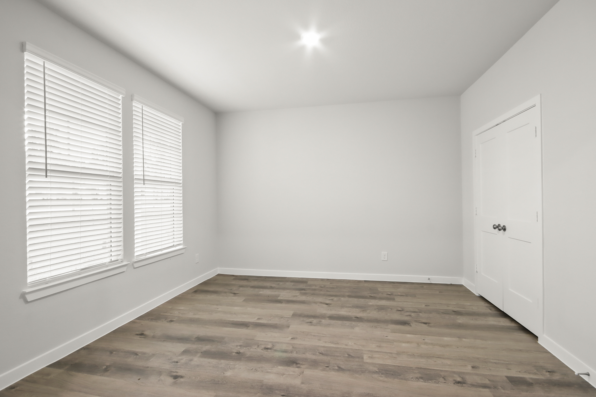 A room with white walls and a wood floor.