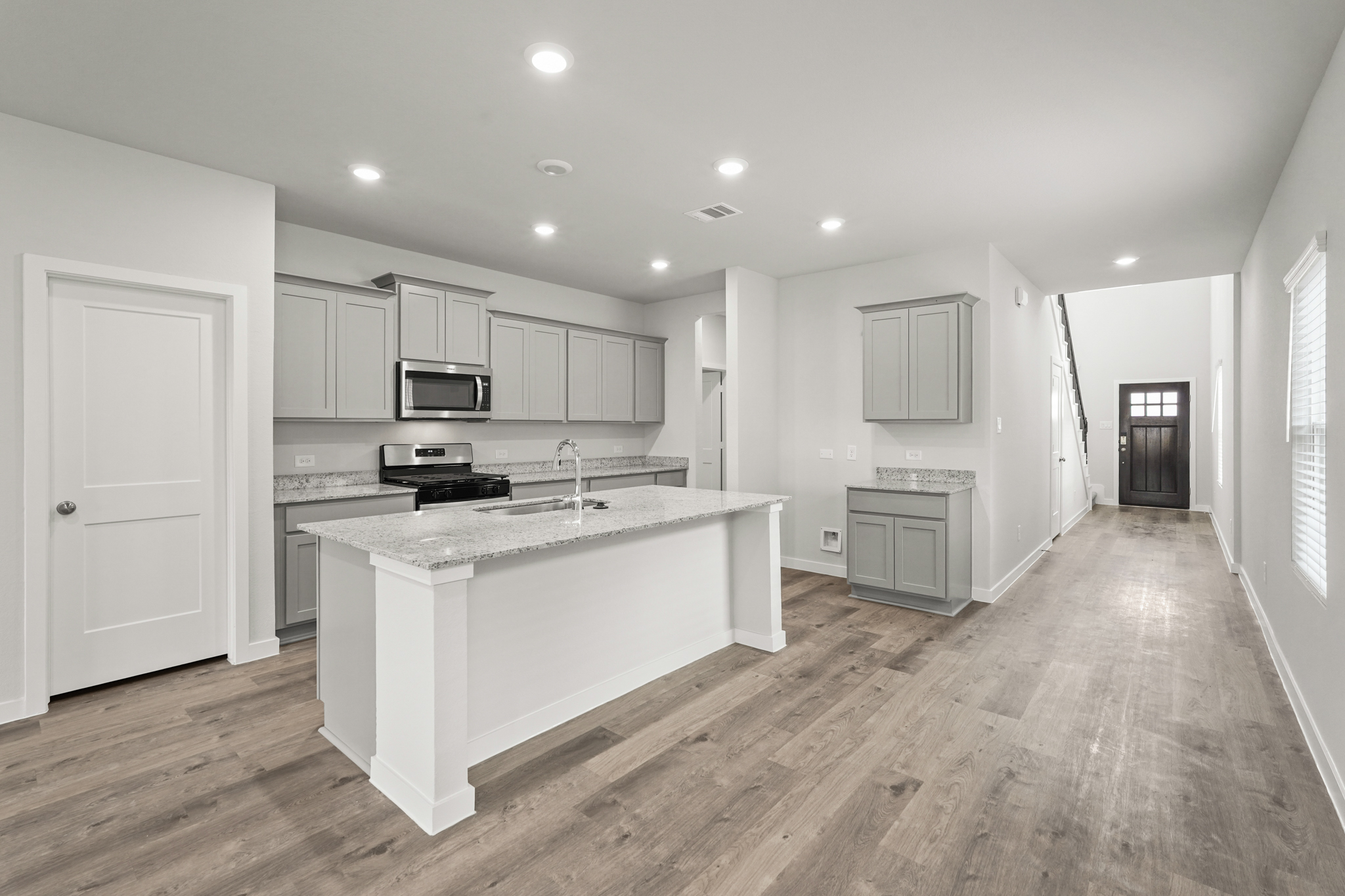 A kitchen with white cabinets.