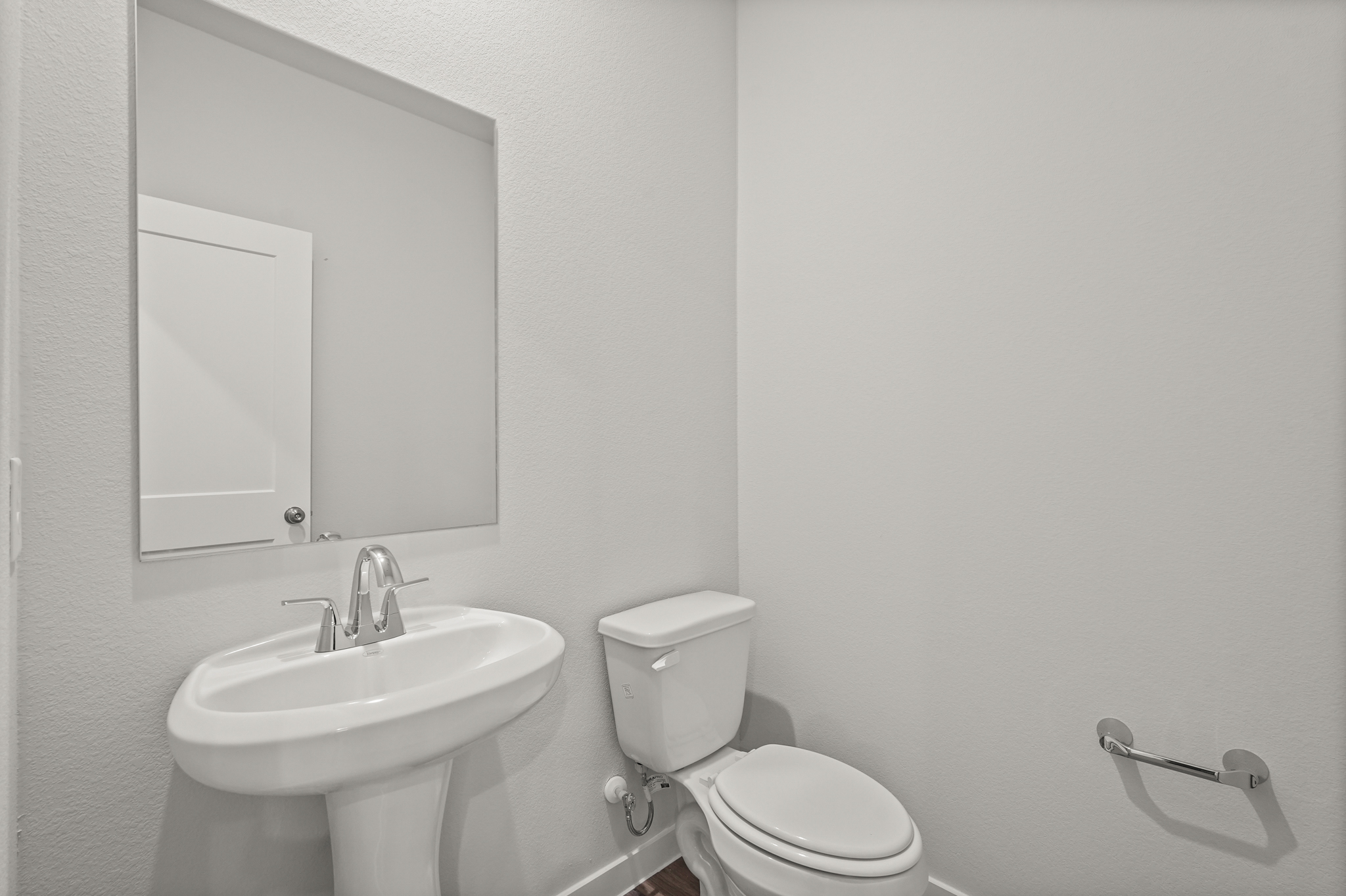 A bathroom with a toilet and sink.