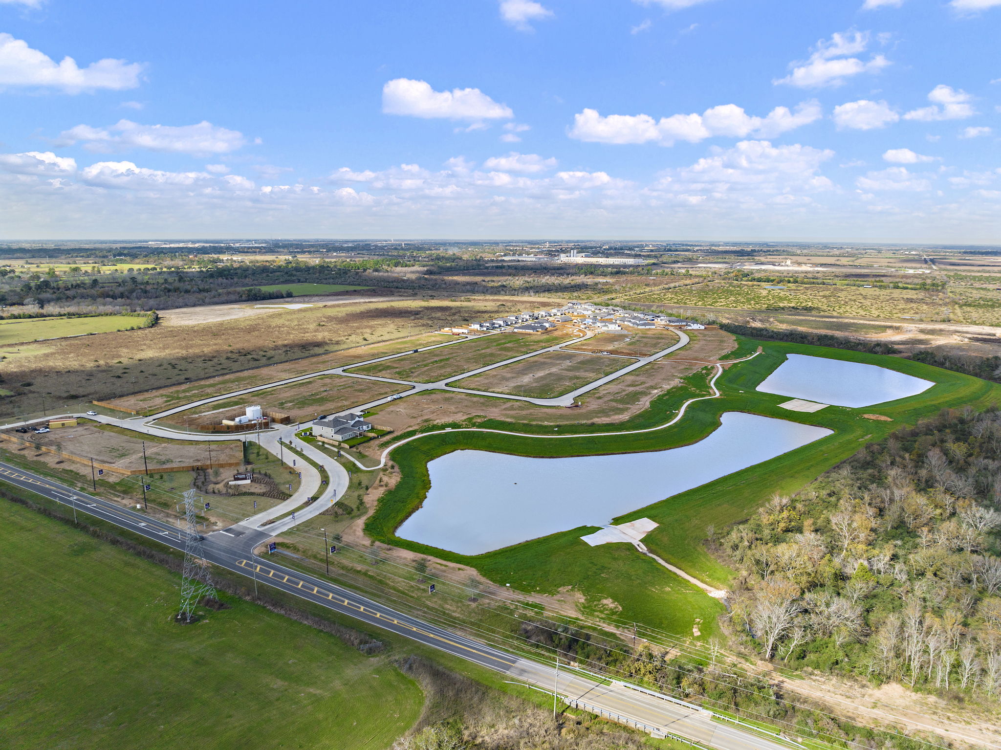 A river running through a valley with Prairie Queen Recreation Area in the background.