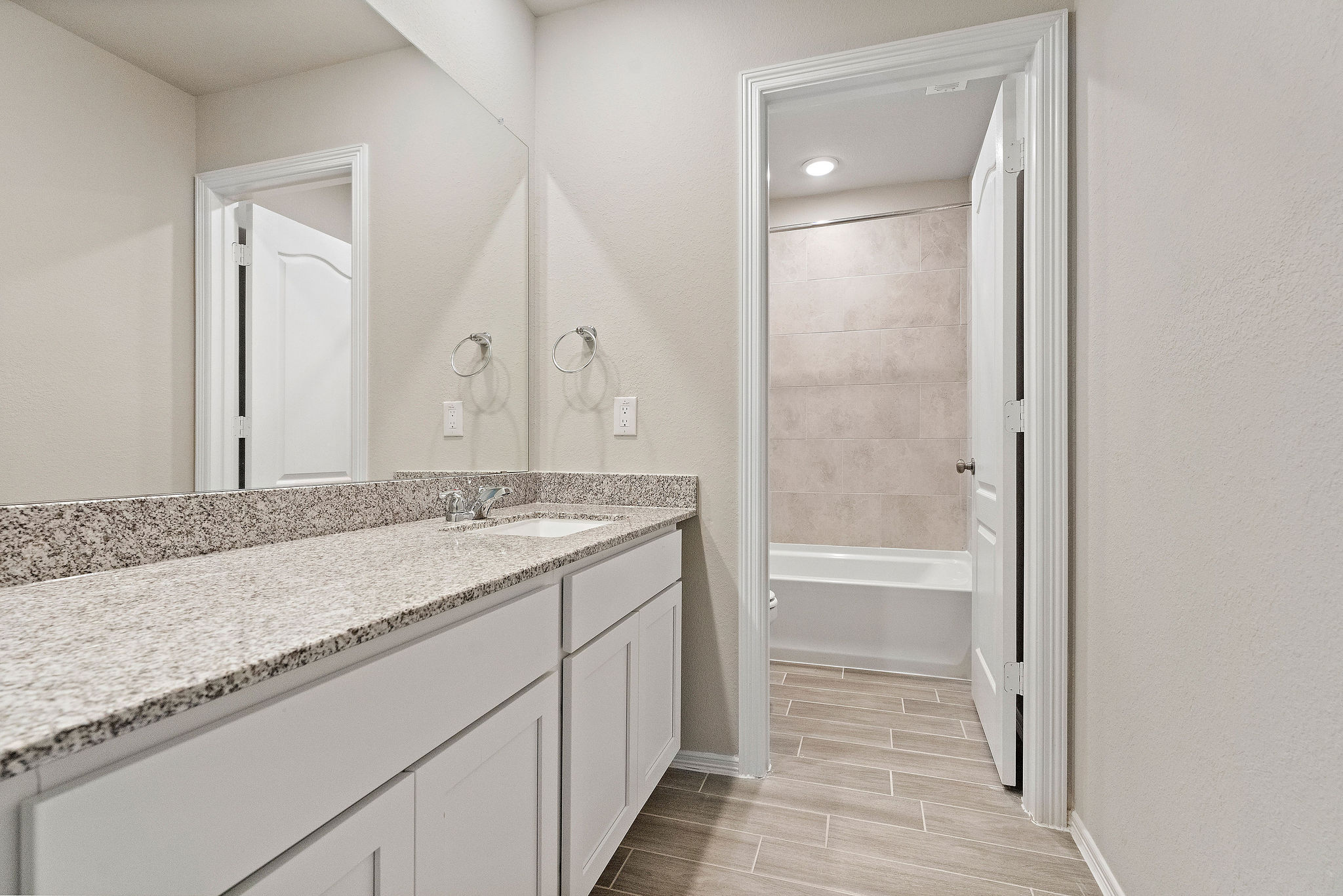 A bathroom with a marble countertop.