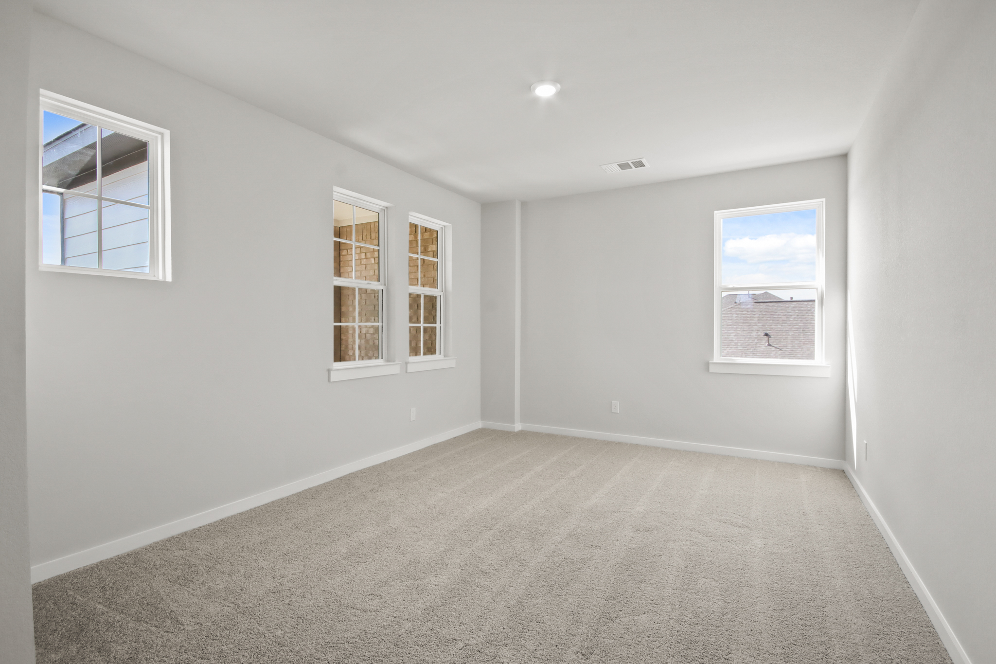 A room with a window and a rug.