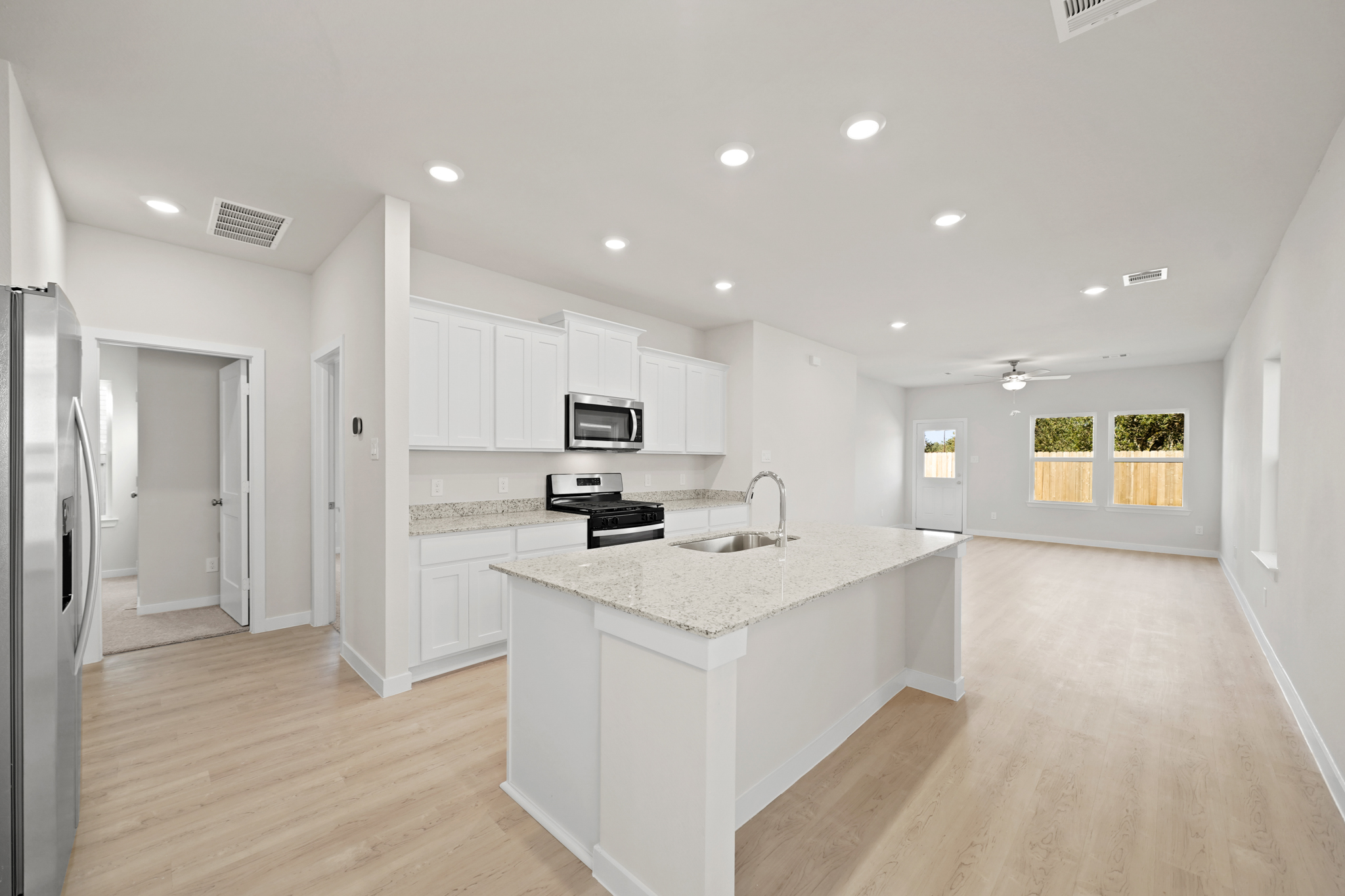 A kitchen with white cabinets.