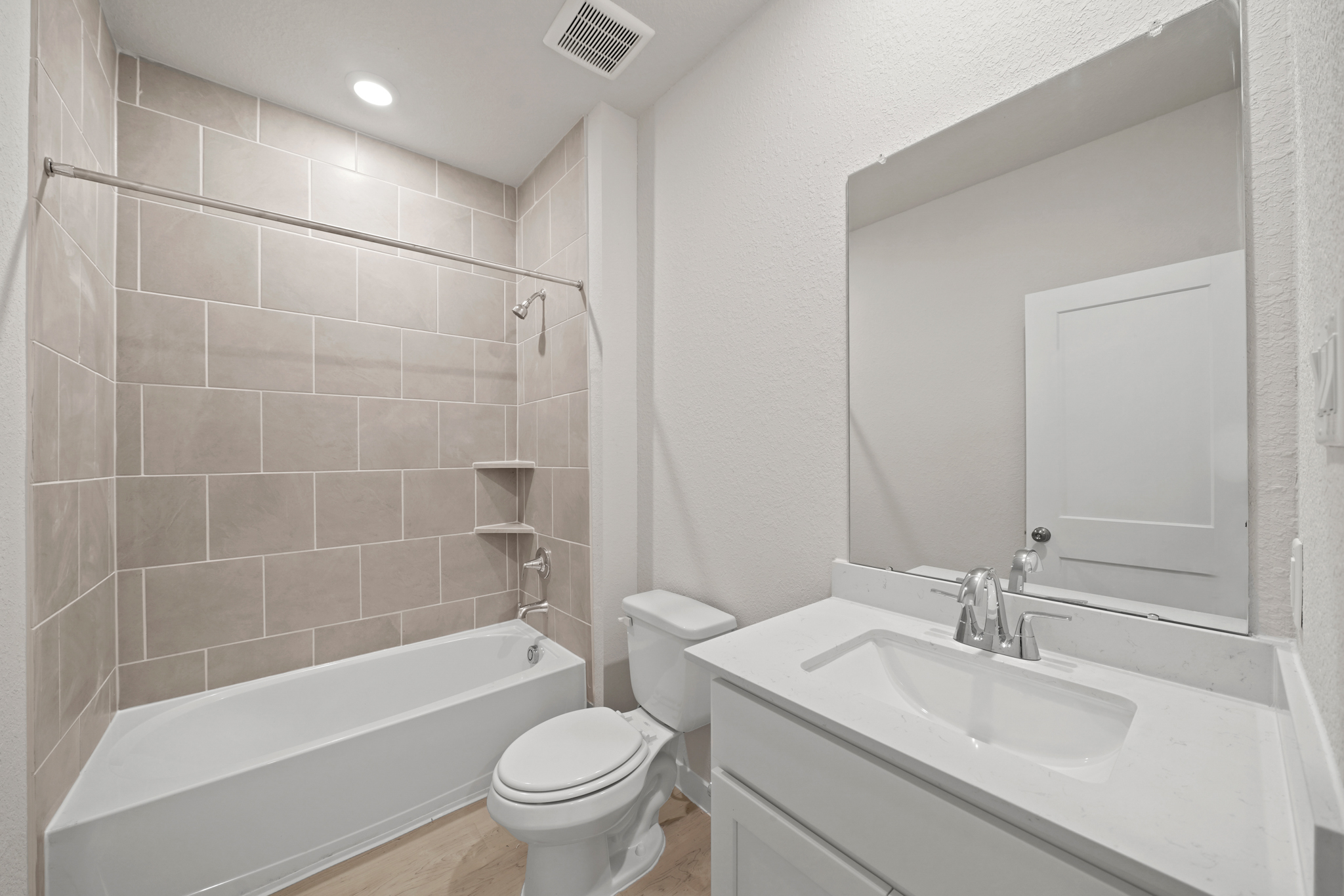 A bathroom with a tub sink and toilet.