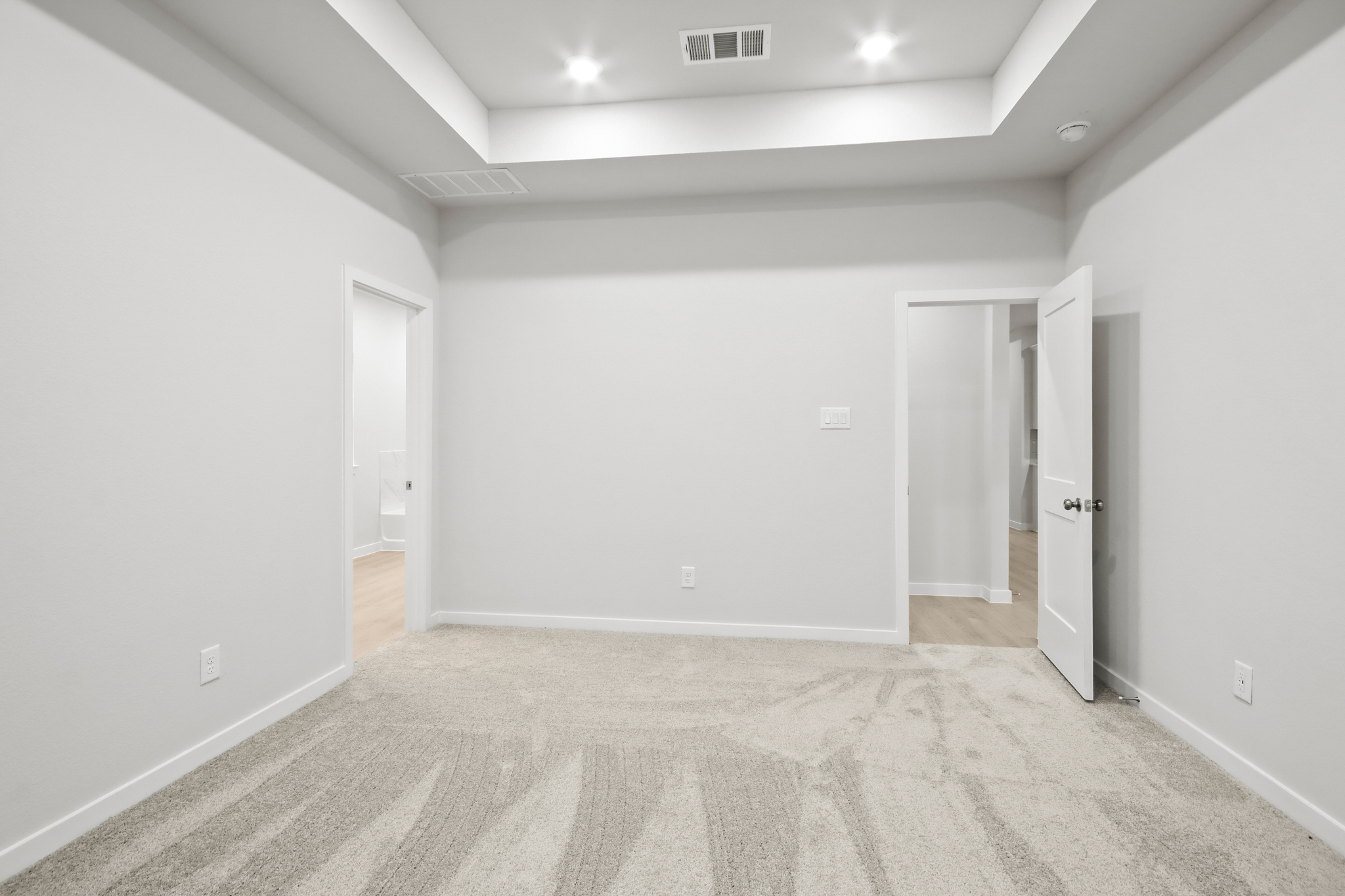 A hallway with white walls.