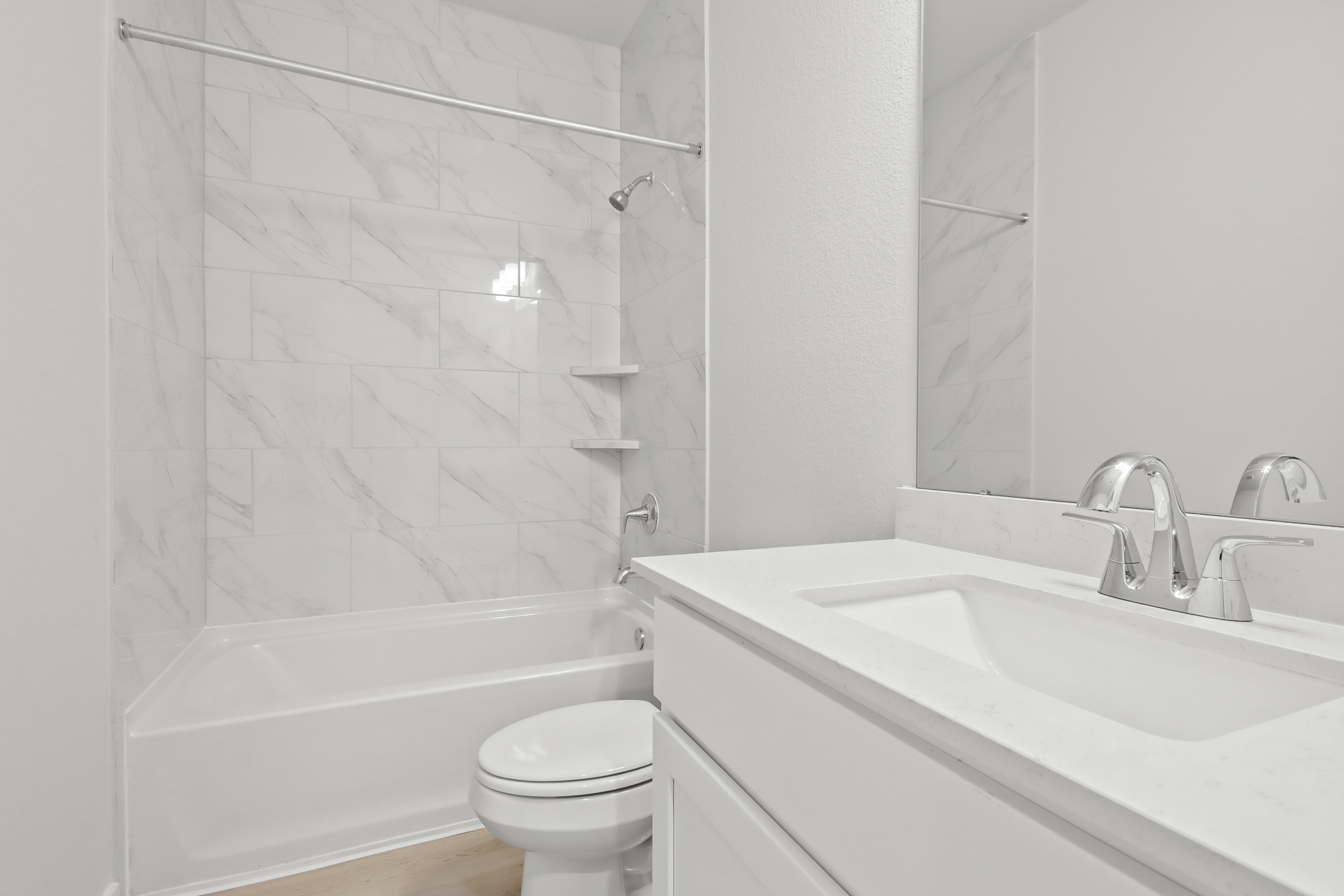A bathroom with a shower and sink.