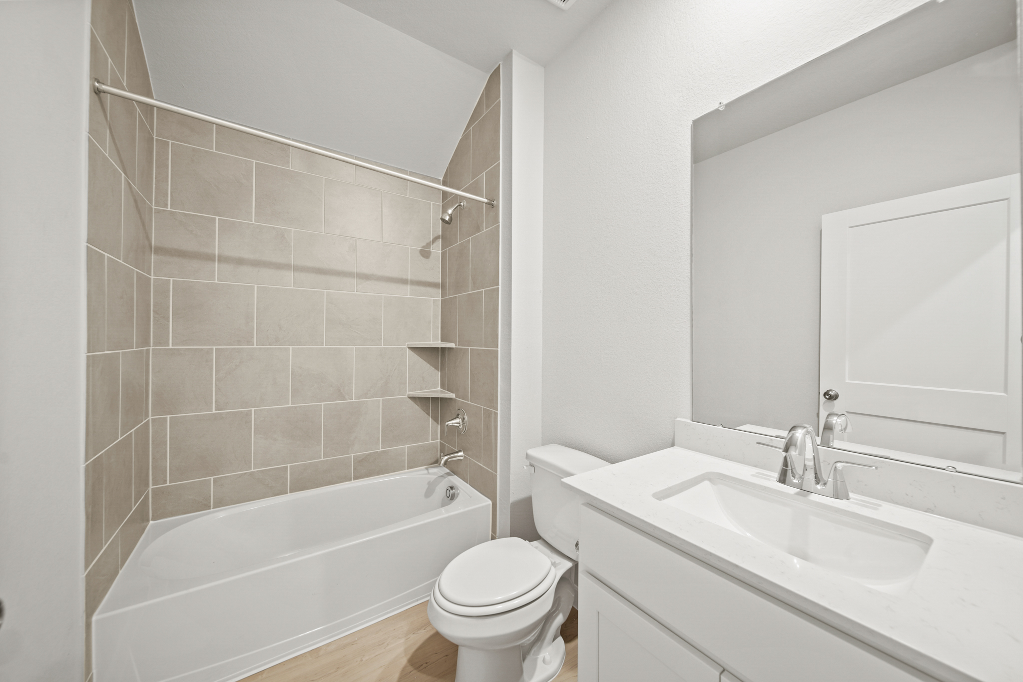 A bathroom with a tub sink and toilet.