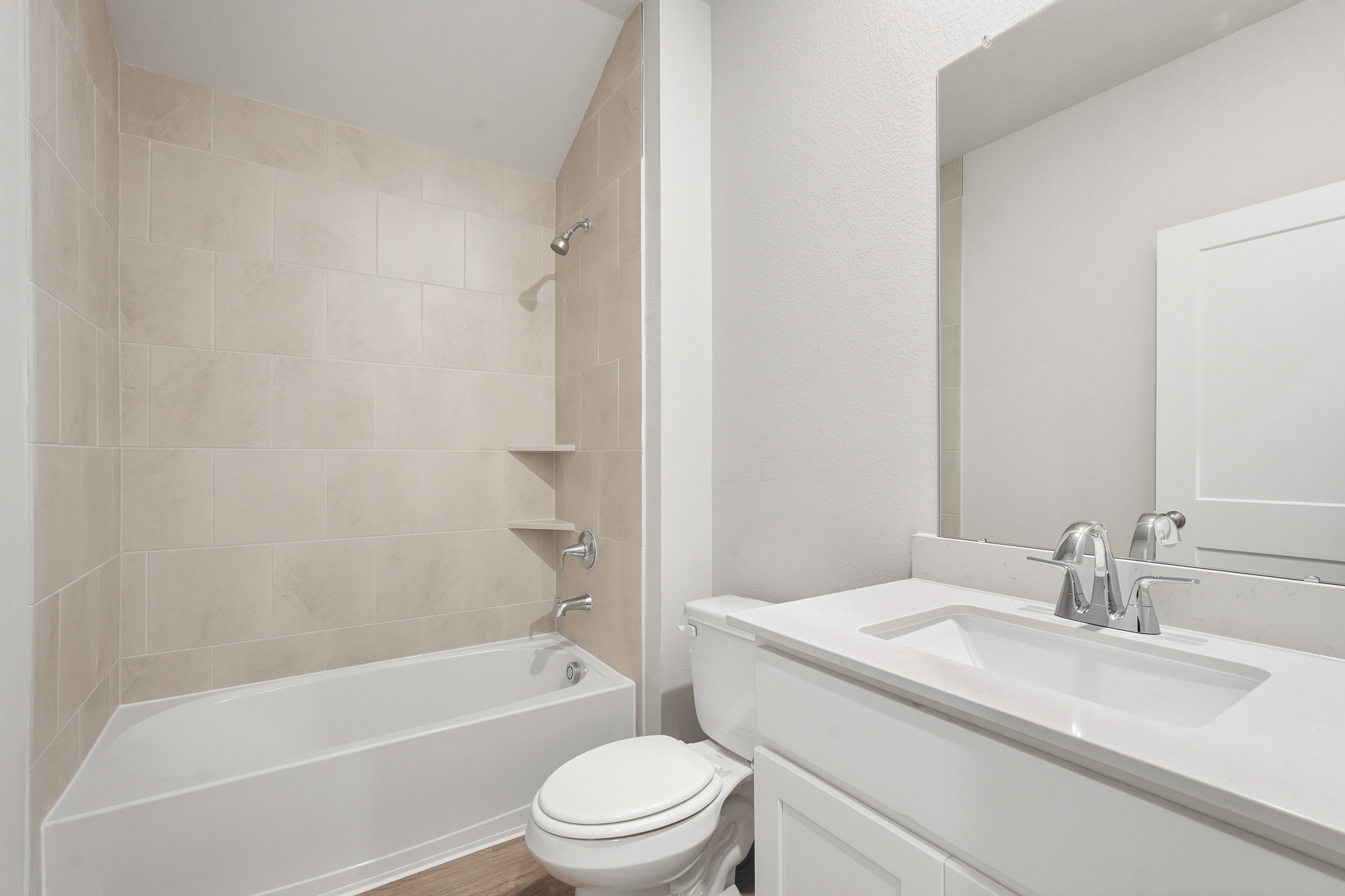 A bathroom with a tub sink and toilet.