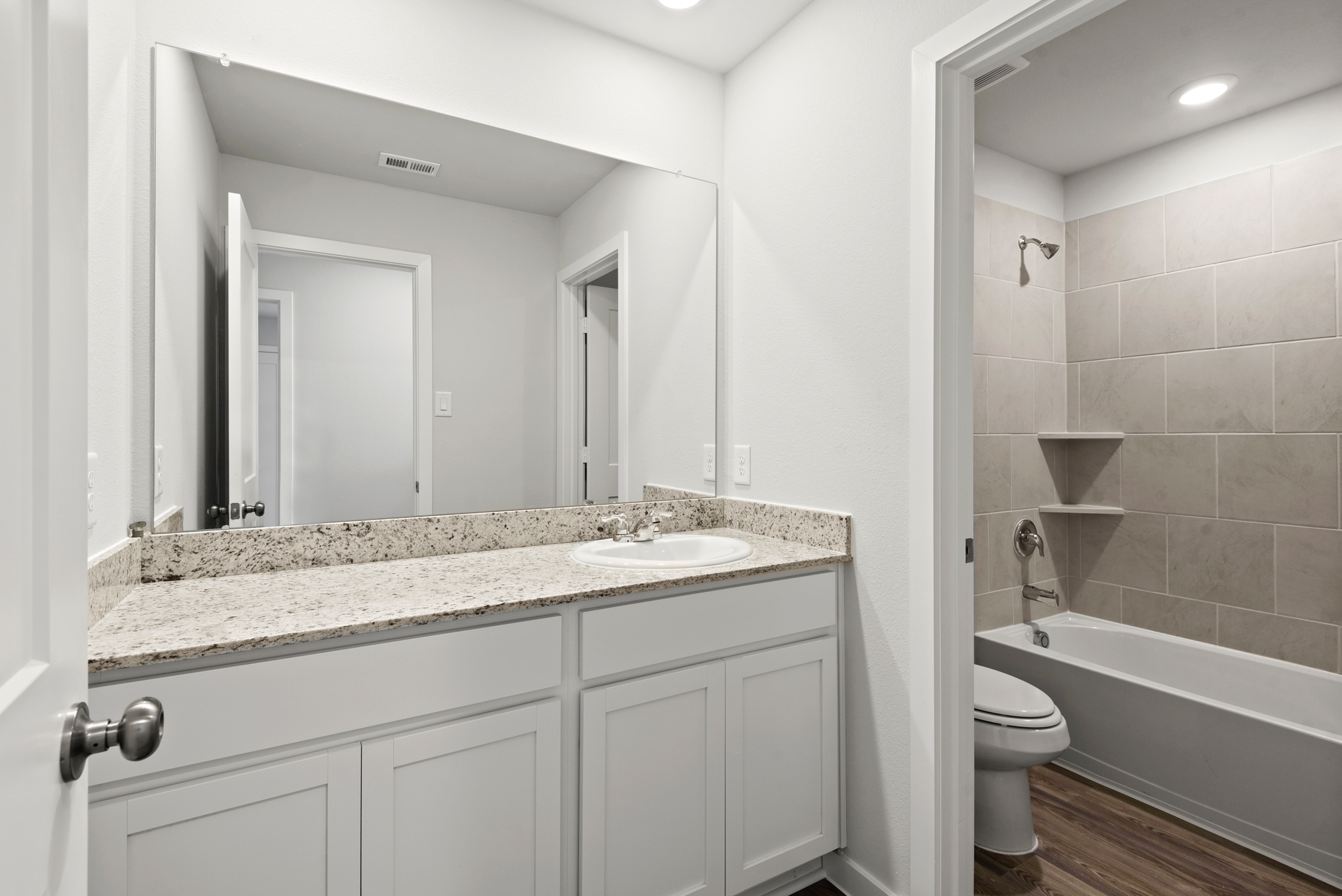 A bathroom with a marble countertop.