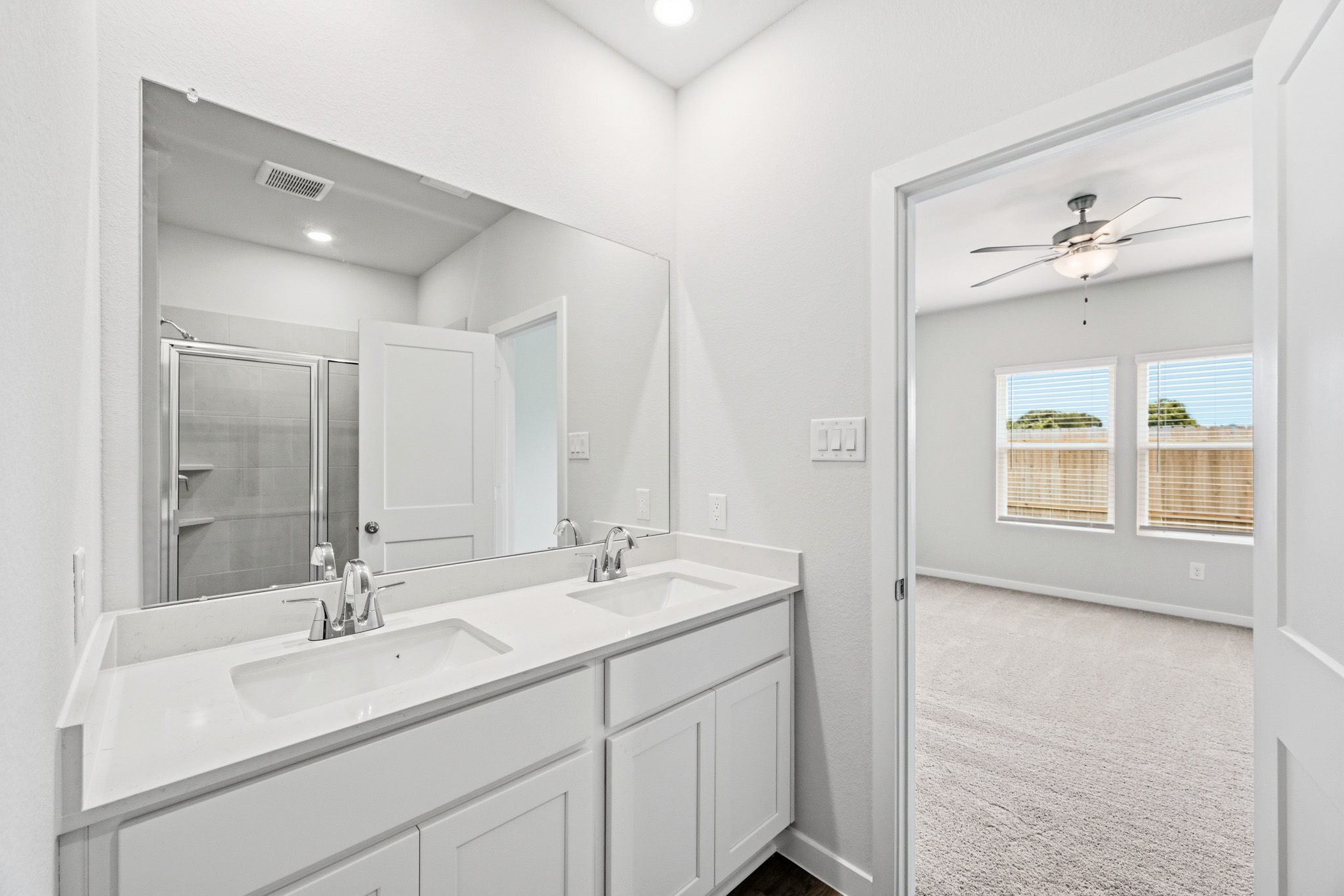 A bathroom with a large mirror.