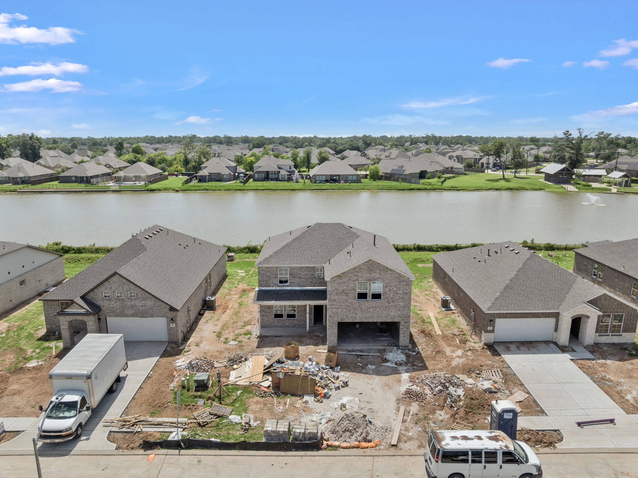 A group of houses next to a body of water.
