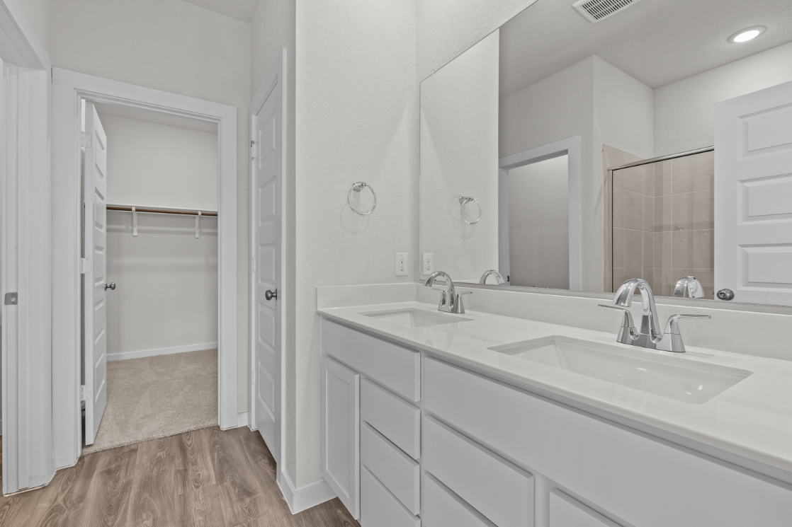 A bathroom with a large mirror.