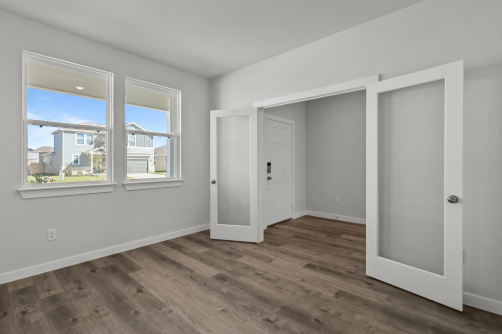 A room with white doors and a window.