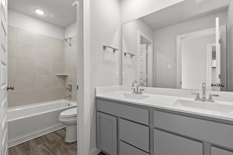 A bathroom with a tub sink and toilet.