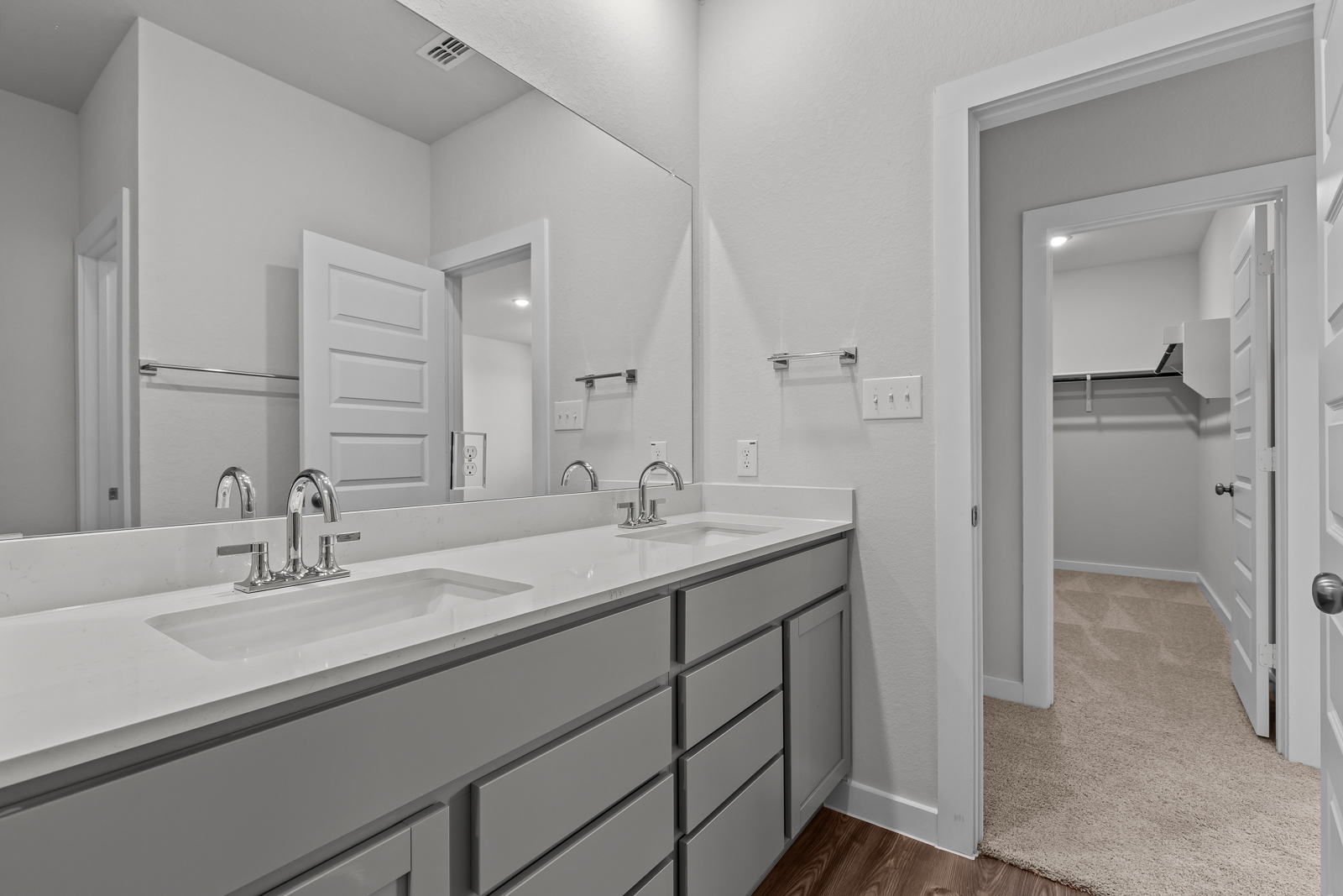 A bathroom with a large mirror.