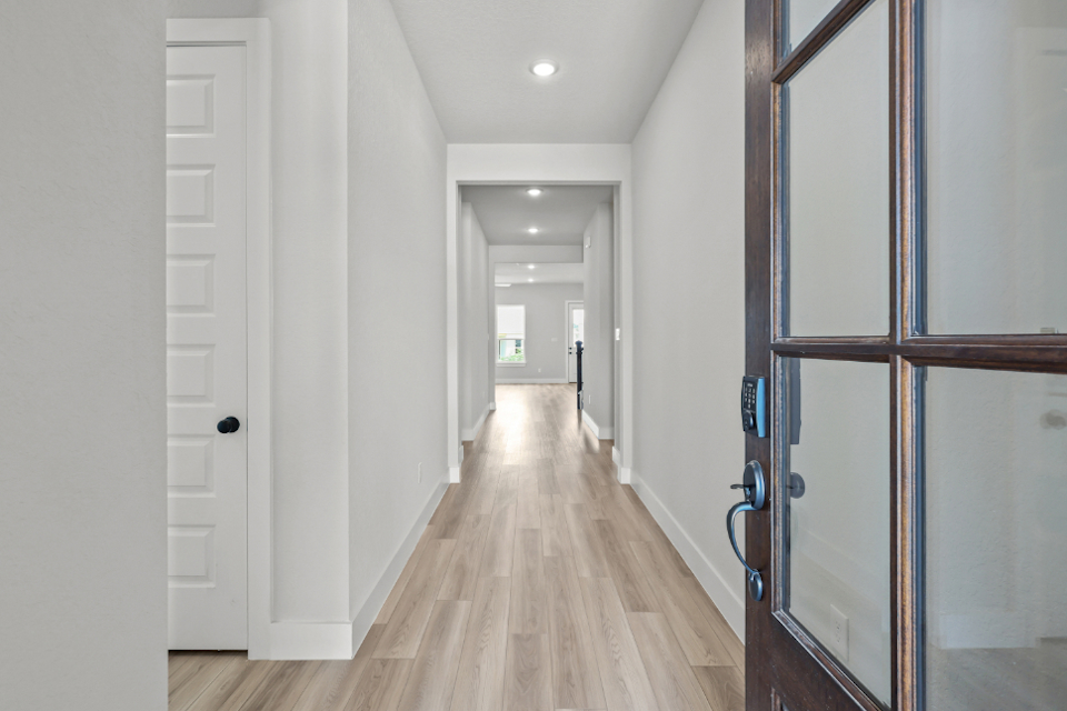 A hallway with white doors.