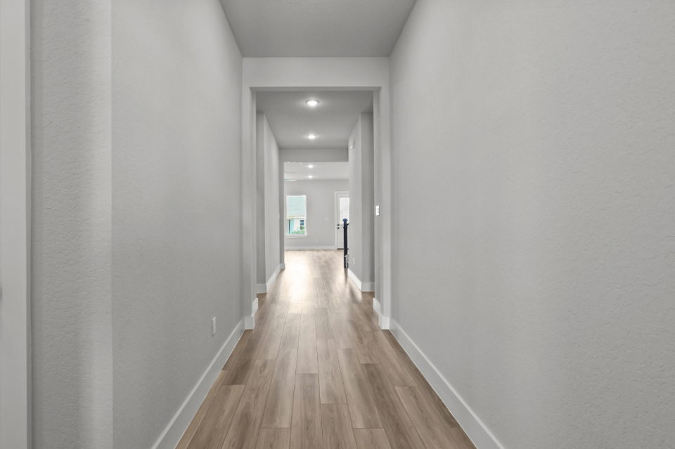 A long hallway with white walls.