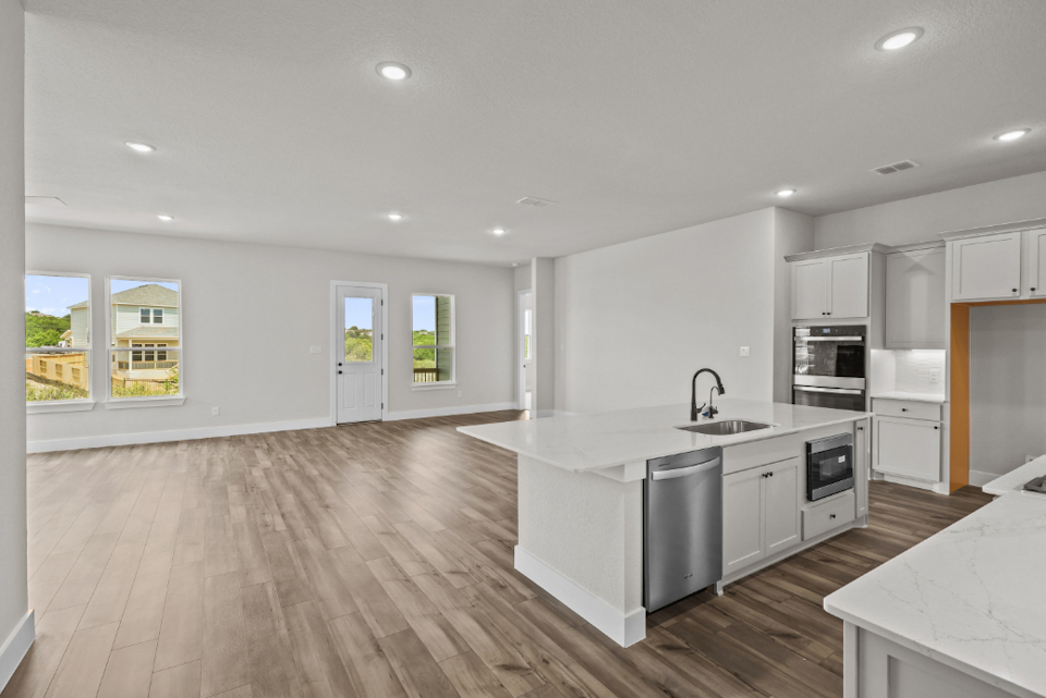 A kitchen with white cabinets.