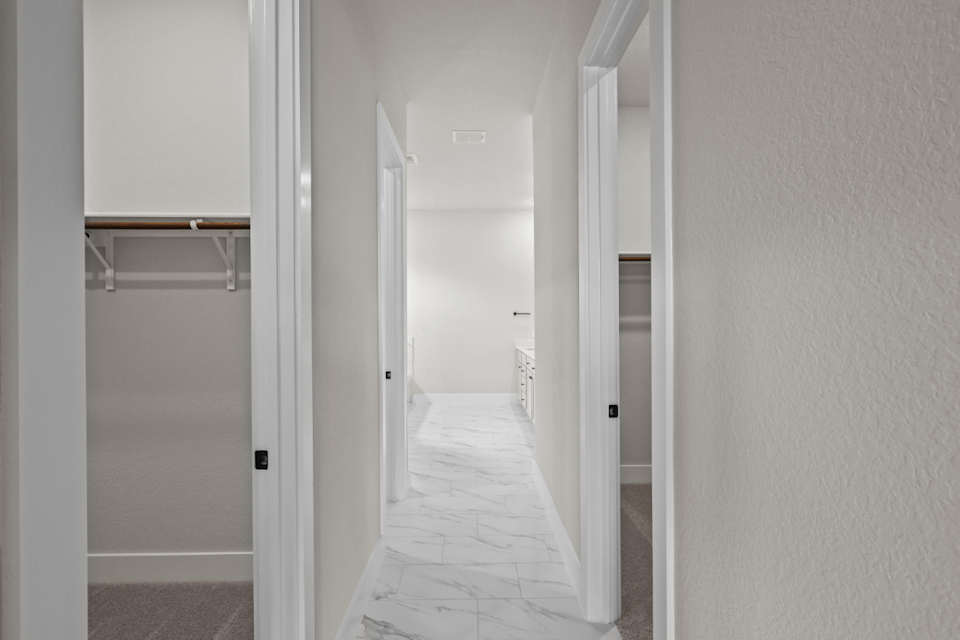 A hallway with white doors.