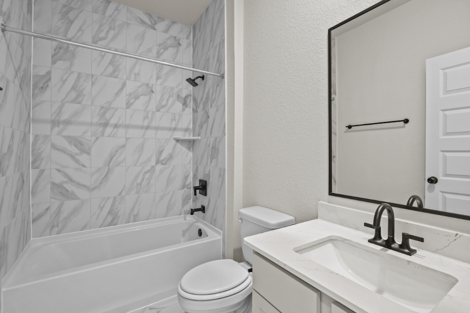 A bathroom with a shower and sink.