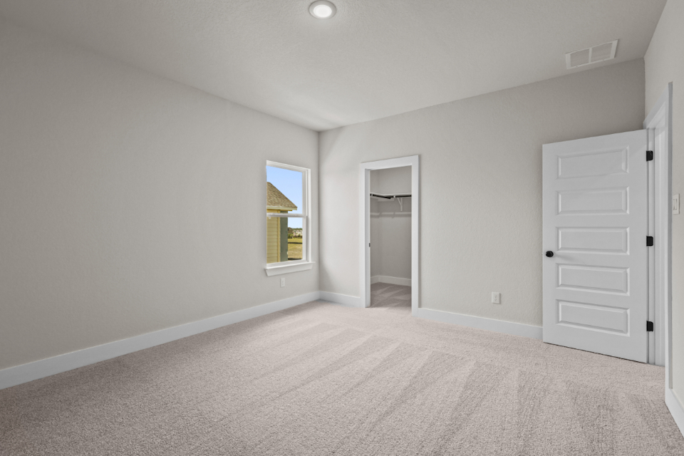 A room with white walls and a window.