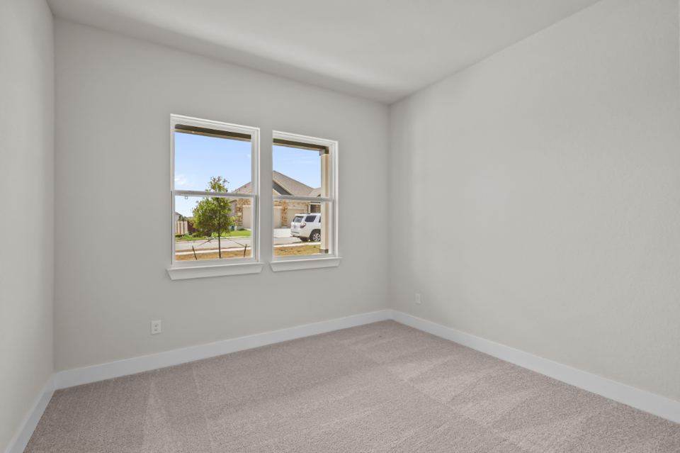 A room with a window and a white wall with a white floor.