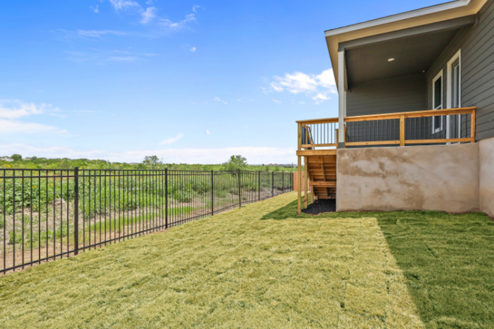 A house with a fence and grass.
