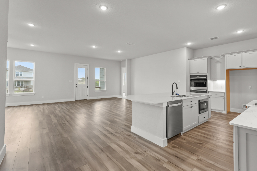 A kitchen with white cabinets.