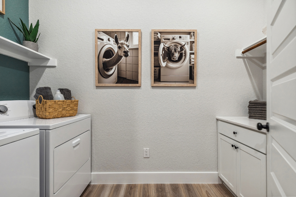 A white kitchen with a white cabinet and a basket with a picture on it.