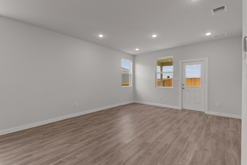 A room with white walls and a wood floor.