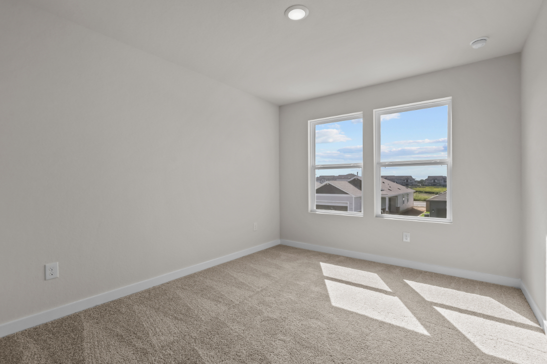 A room with a window and a rug in it.