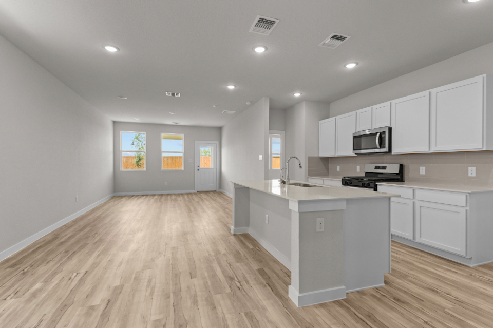 A kitchen with white cabinets.