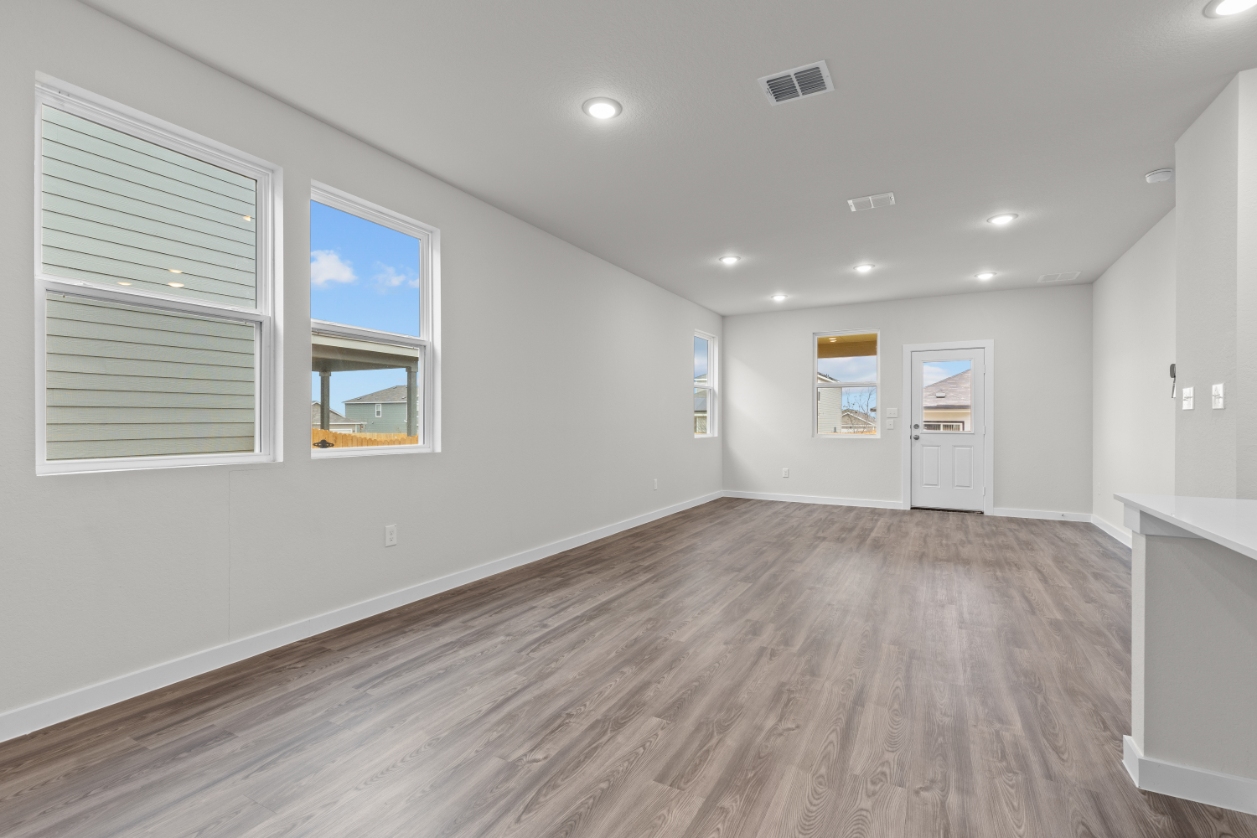 A room with a wood floor and white walls.