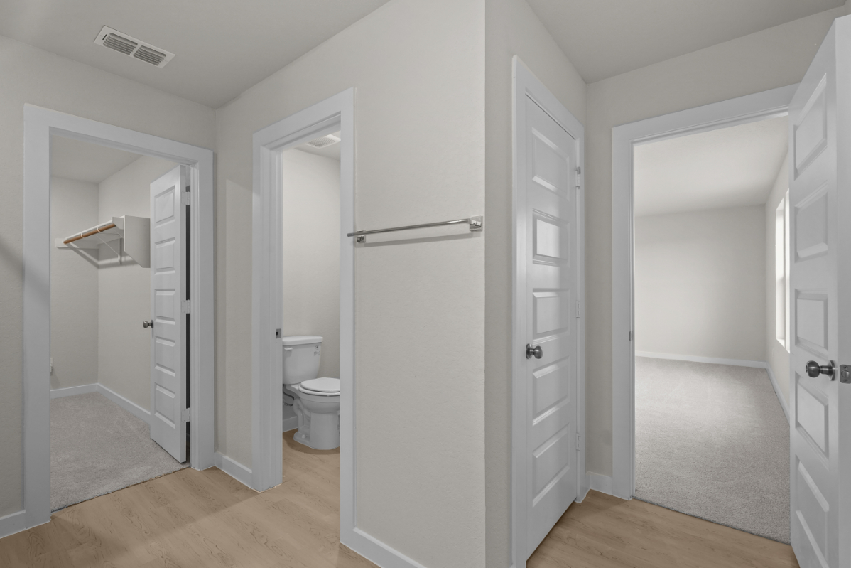 A bathroom with white doors.