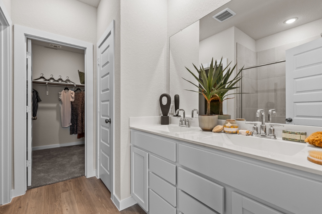 A bathroom with a sink and a shower unit.