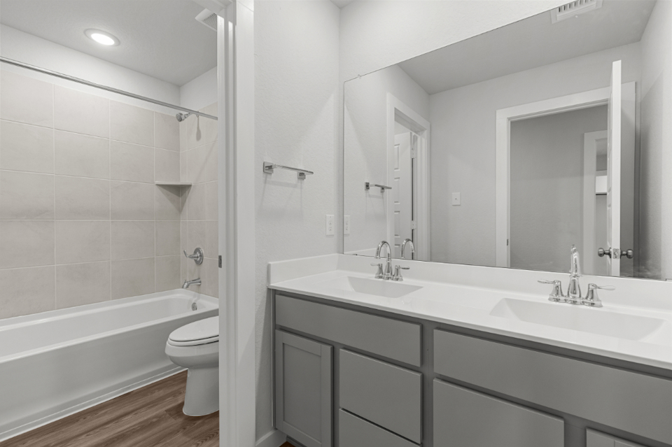 A bathroom with a tub sink and toilet.