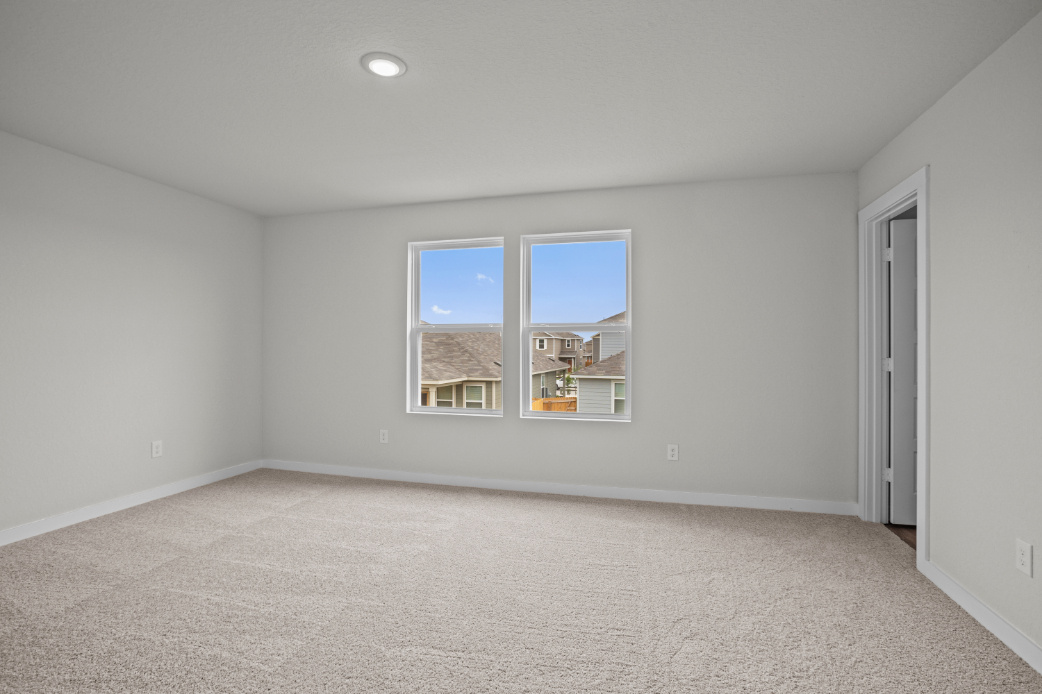 A room with a window and carpet.