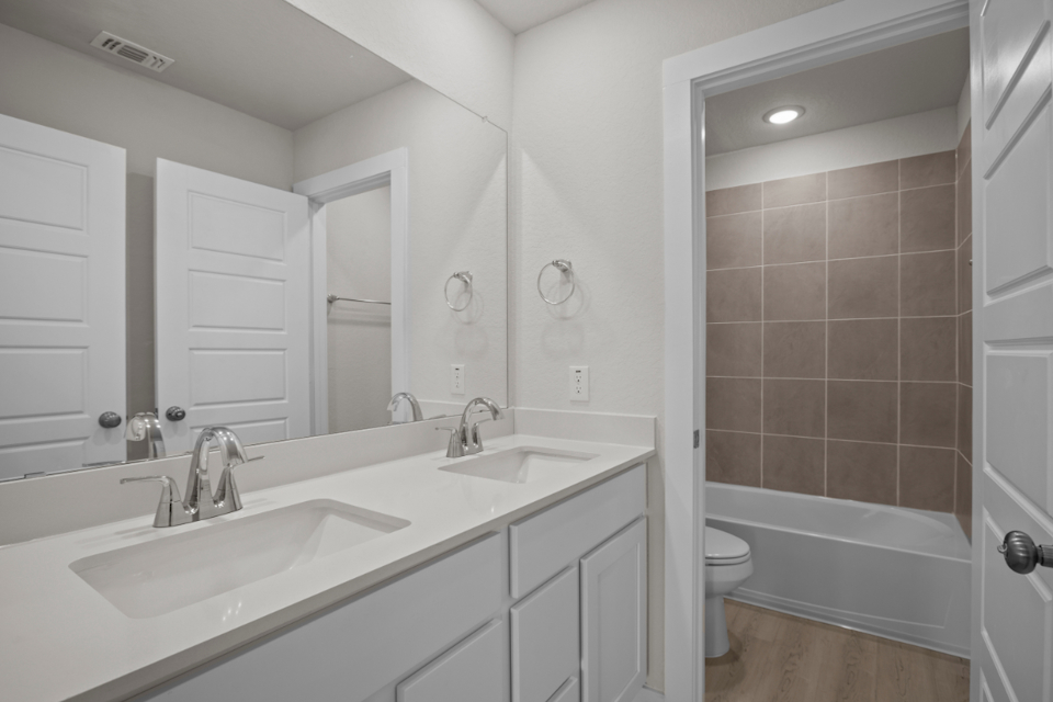 A bathroom with a tub sink and toilet.