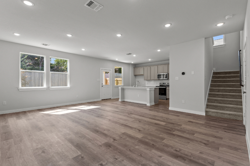A large kitchen with wood floors.