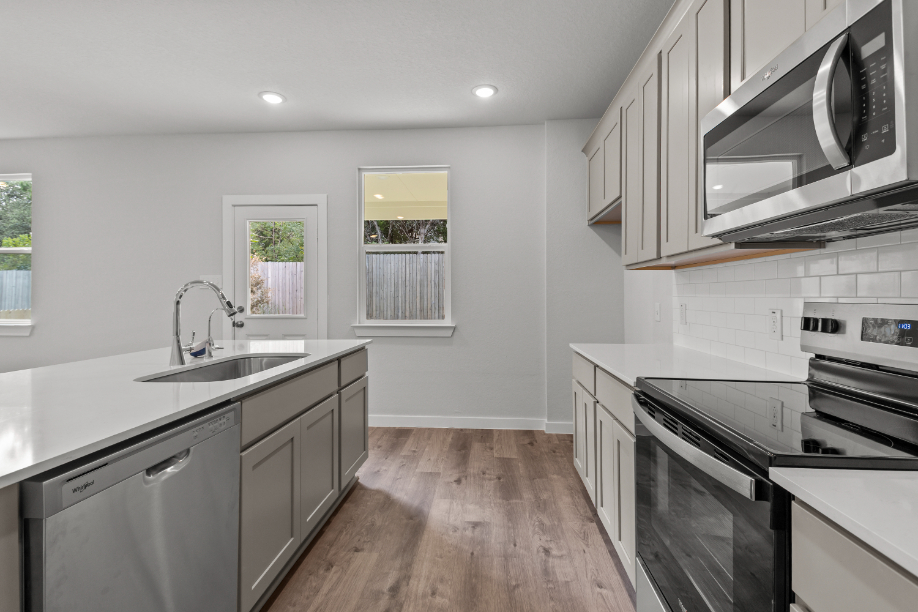 A kitchen with white cabinets.