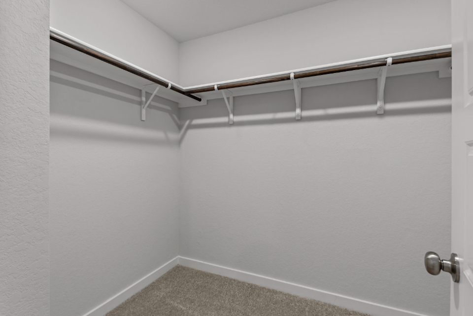 A white wall with a metal railing.
