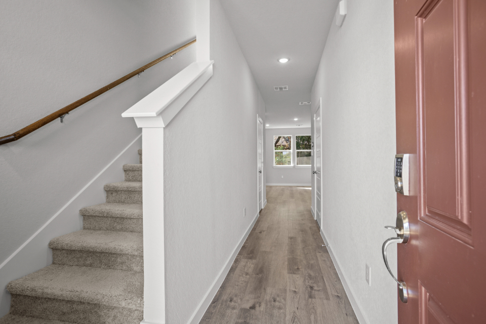 A hallway with white walls.