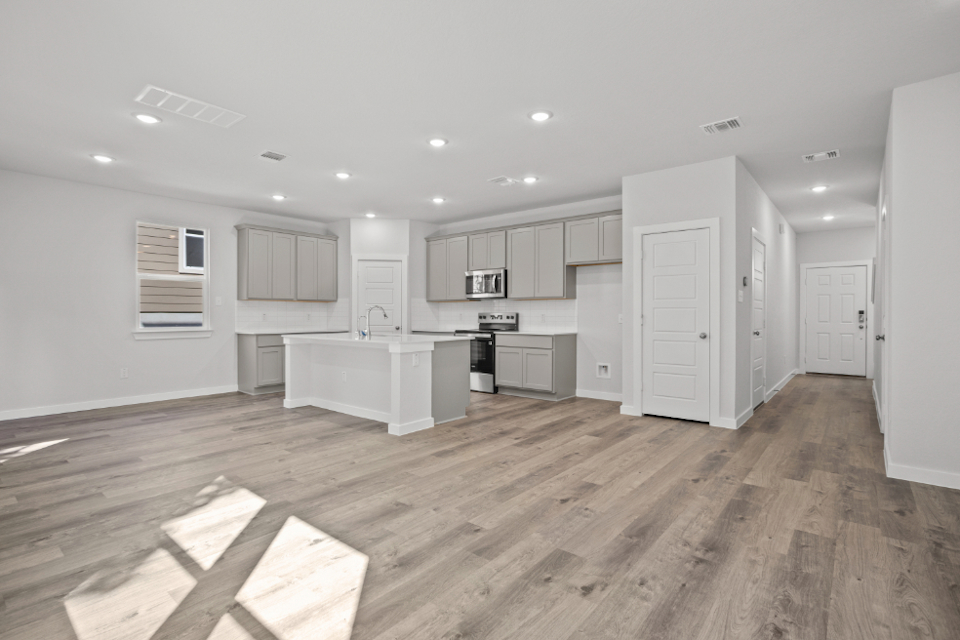 A kitchen with white cabinets.