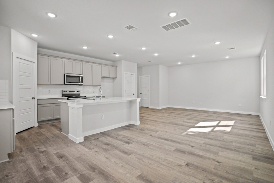 A kitchen with white cabinets.