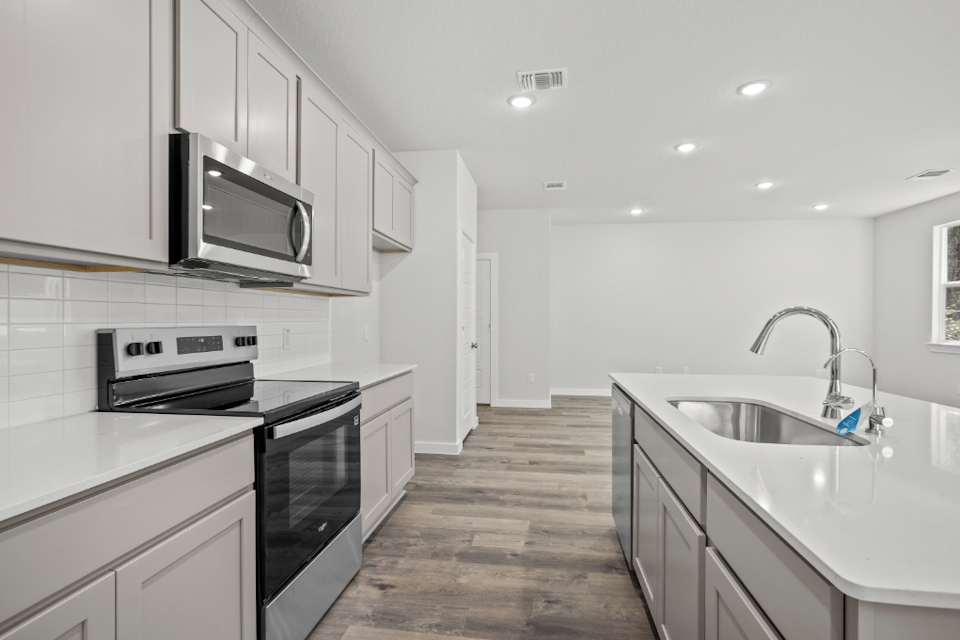 A kitchen with white cabinets.
