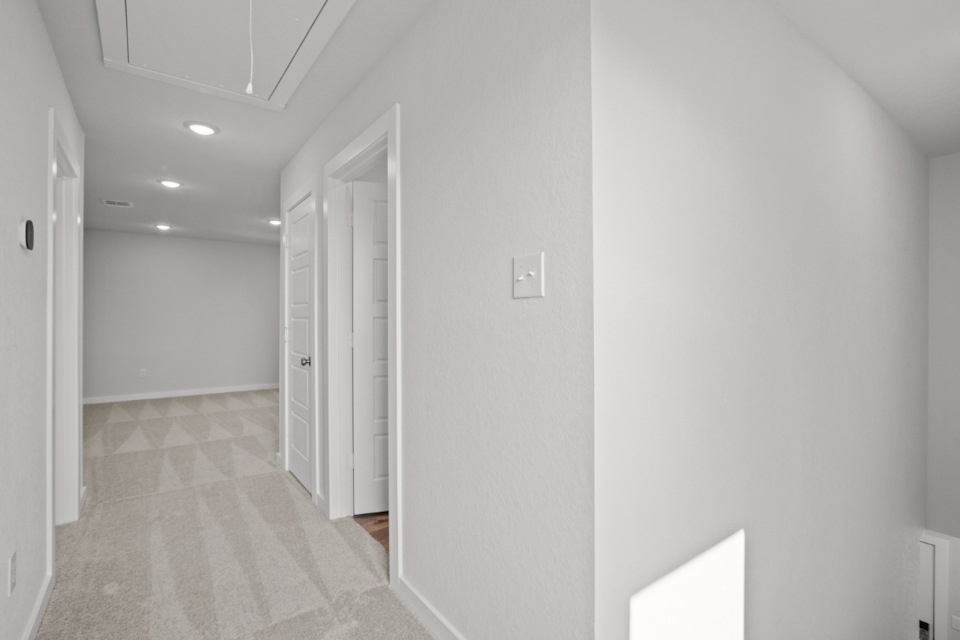A hallway with white walls.