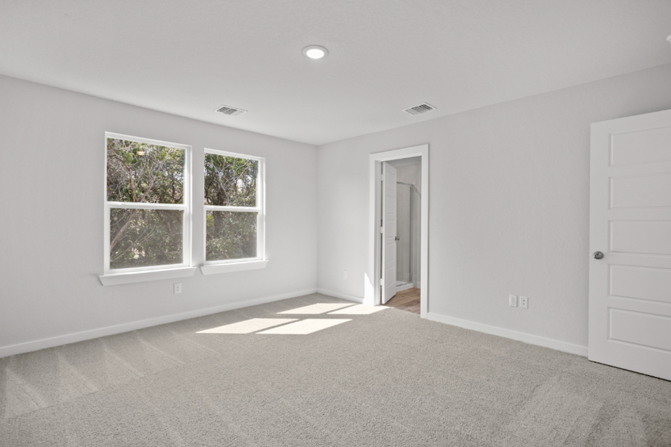 A room with white walls and windows.