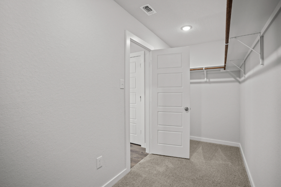 A hallway with white doors.