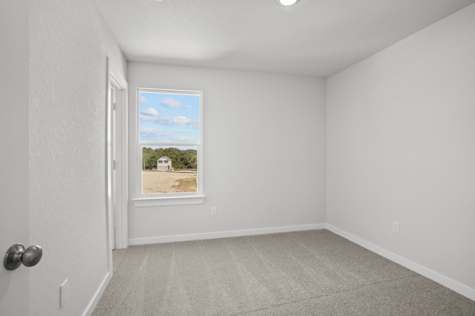 A room with a window and a door.