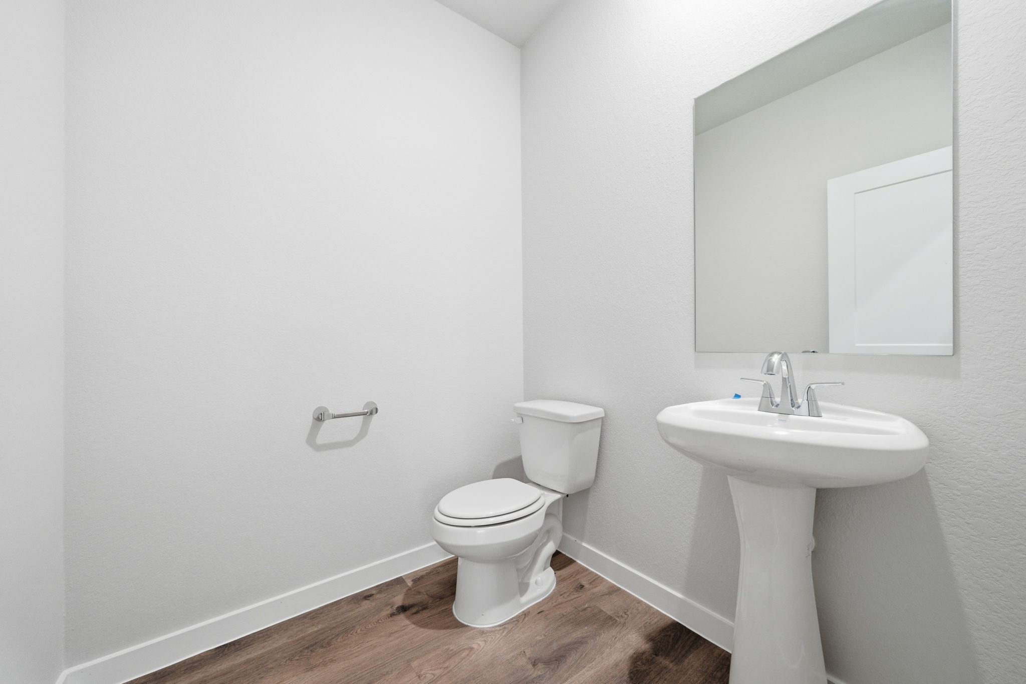 A bathroom with a toilet and sink.